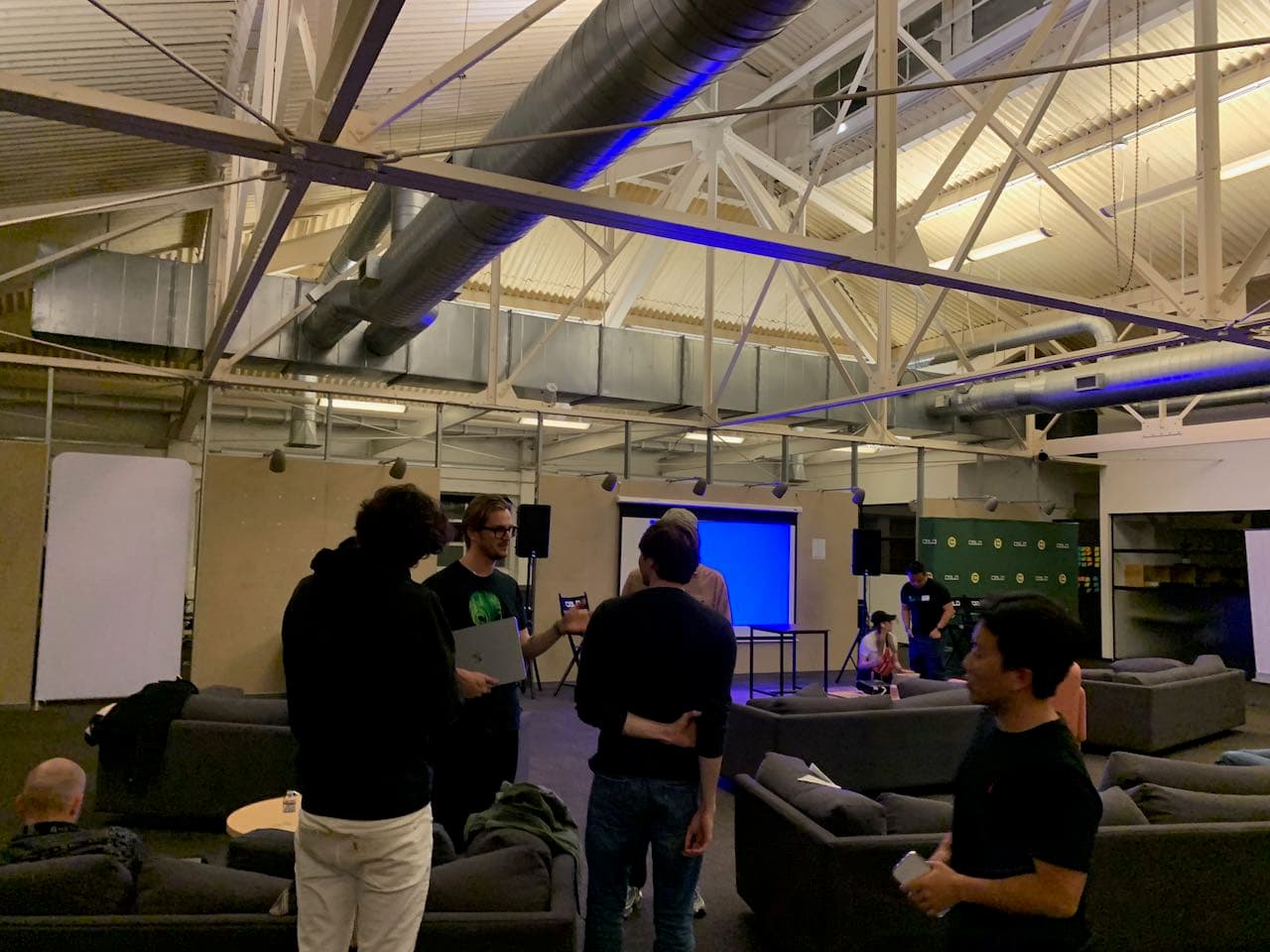 Industrial space with exposed ceiling and blue lighting