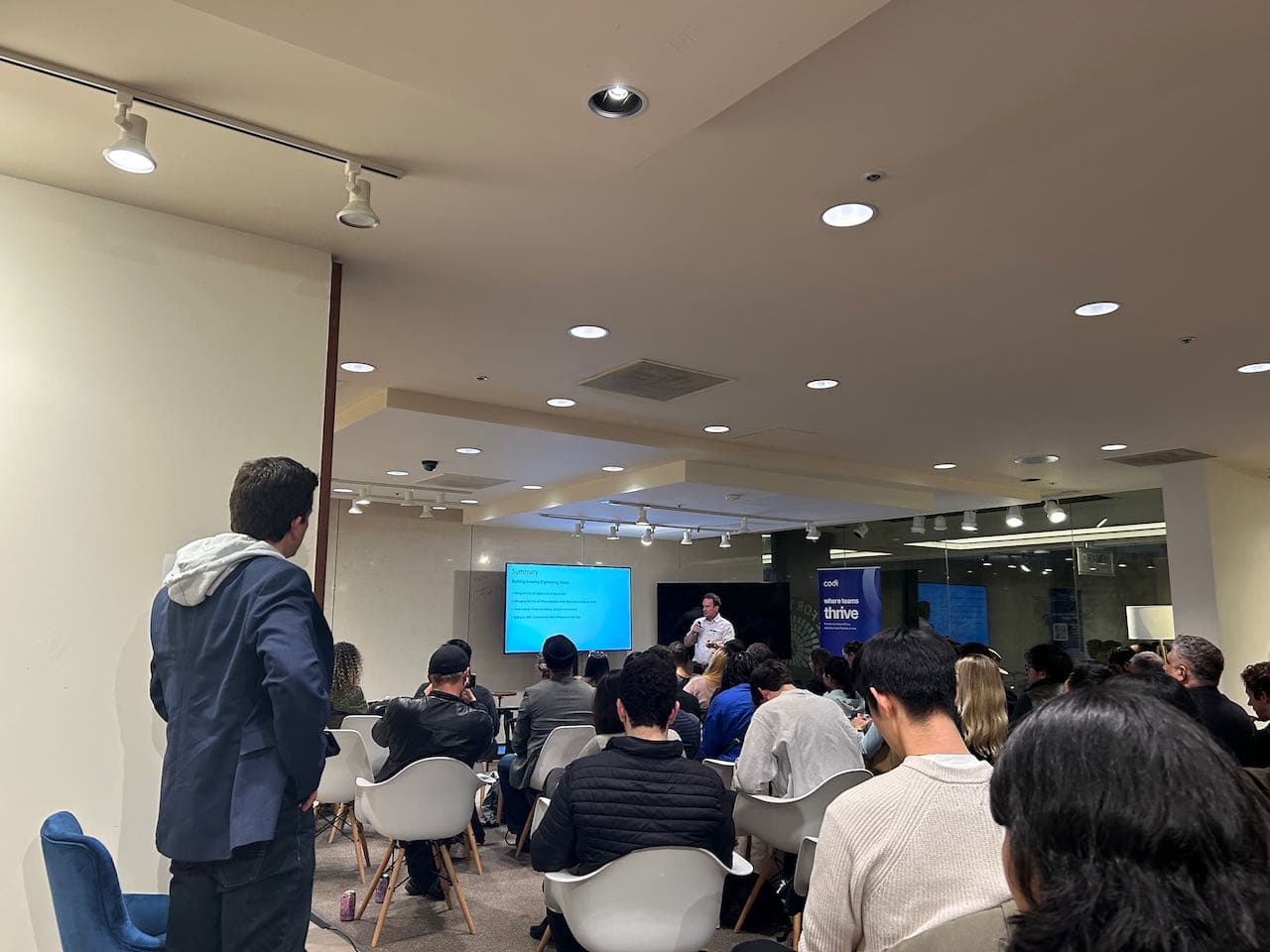 AI and Financial Services presentation with audience in white chairs